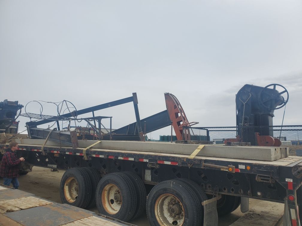 A pumpjack is awaiting to be reconditioned and put back into service